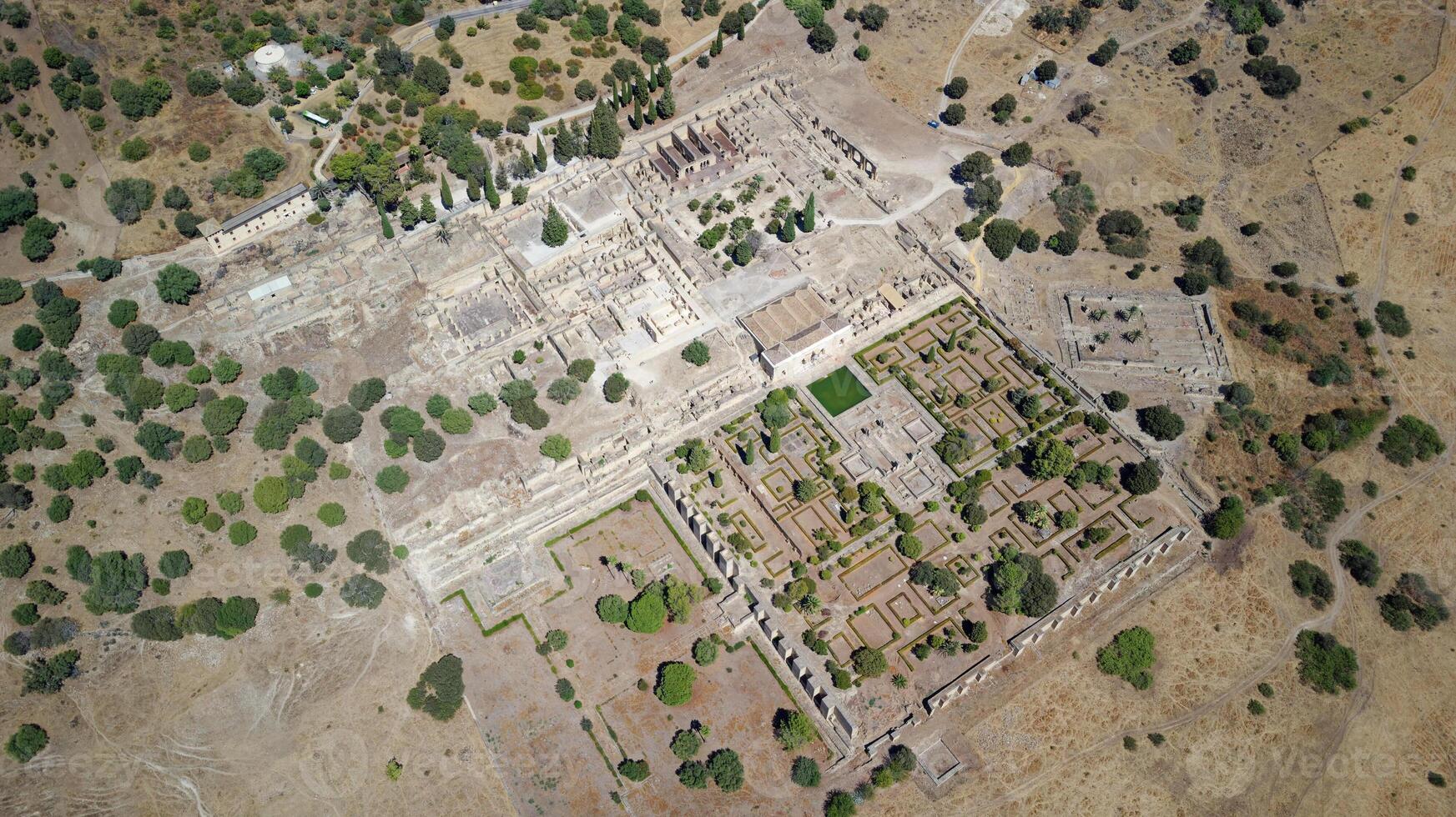 Aerial drone view of the Caliphate City of Medina Azahara in Cordoba. Archaeological site. Unesco World Heritage, Spain. Ancient civilization. Historic place. Touristic destination for holidays. photo