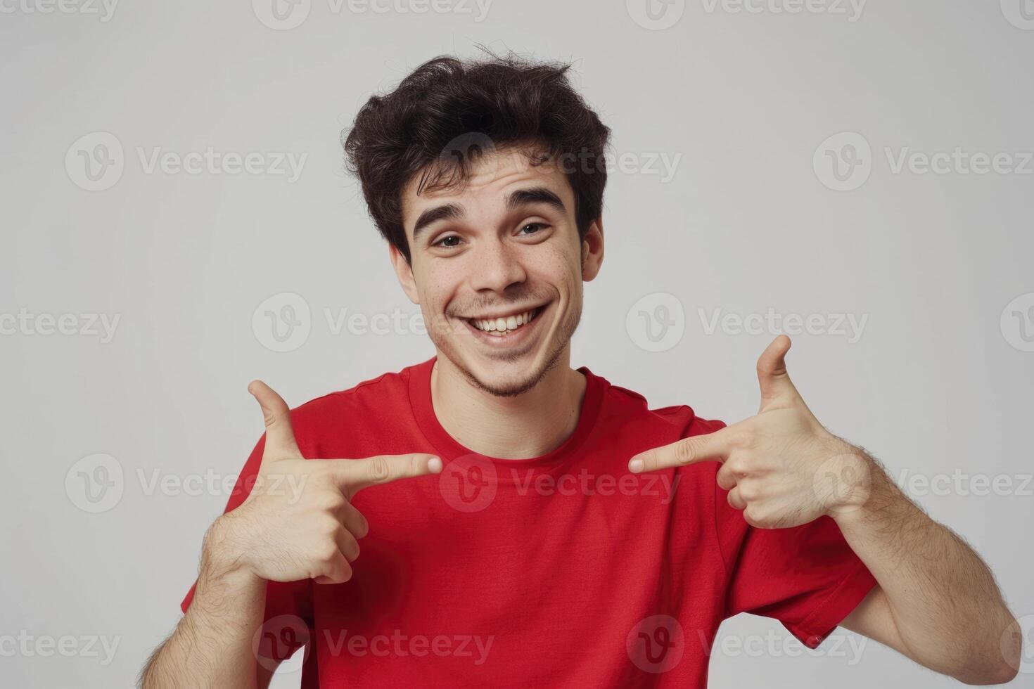 Handsome man in red shirt smiling and pointing. photo