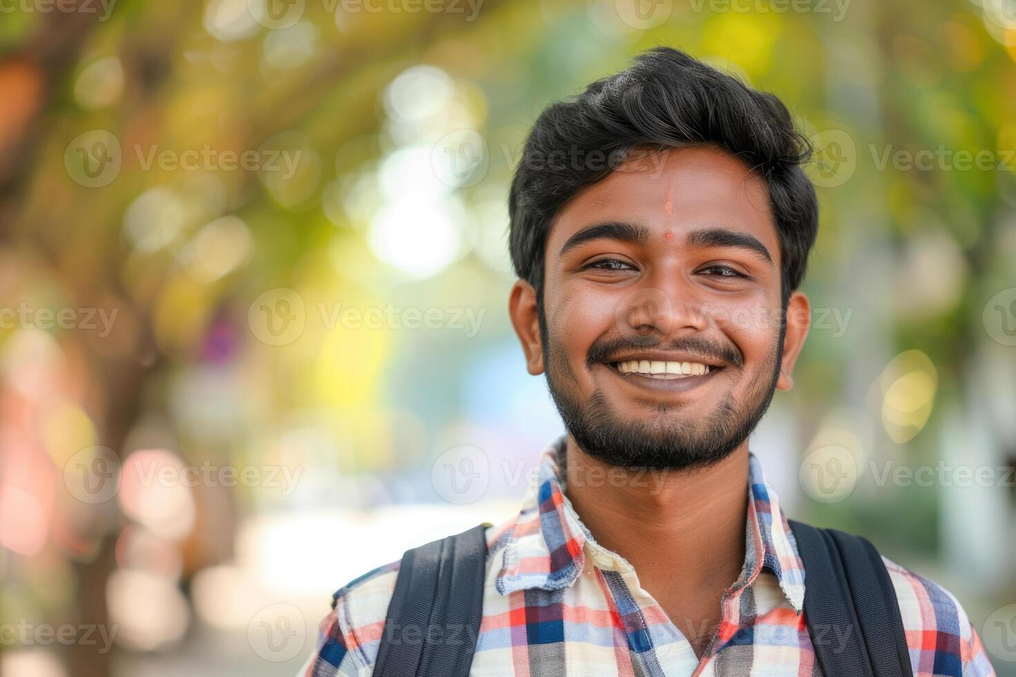 Portrait of a casually dressed smiling Indian young man photo