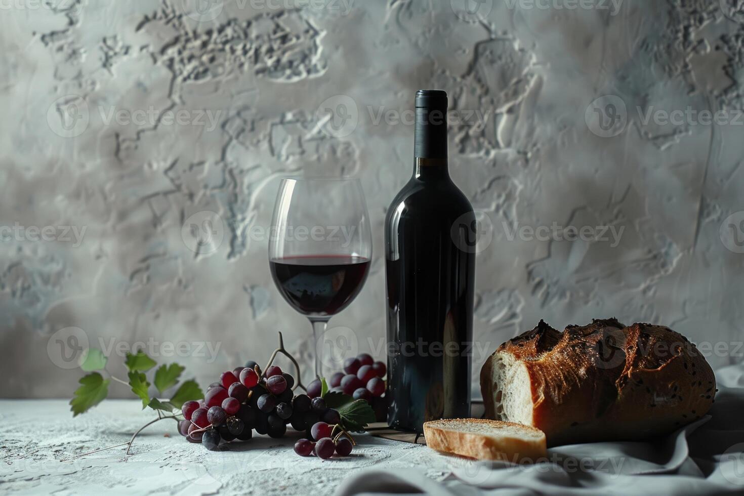 Wine bottle and wine glass still life with grapes and bread on white plaster background. Wine photo