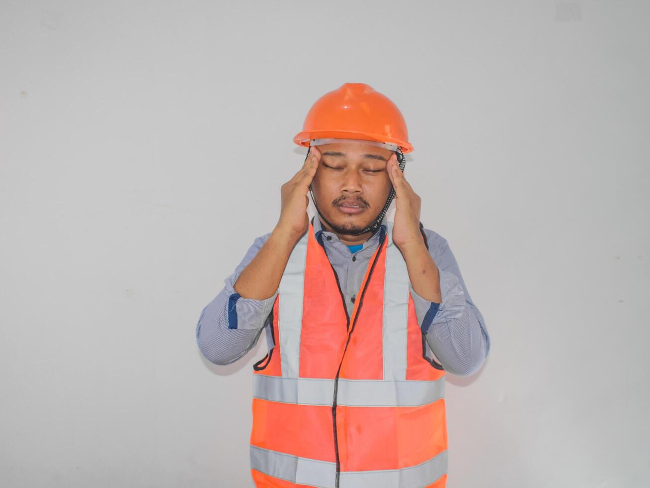 Adult Asian man grabbing his head showing desperate photo