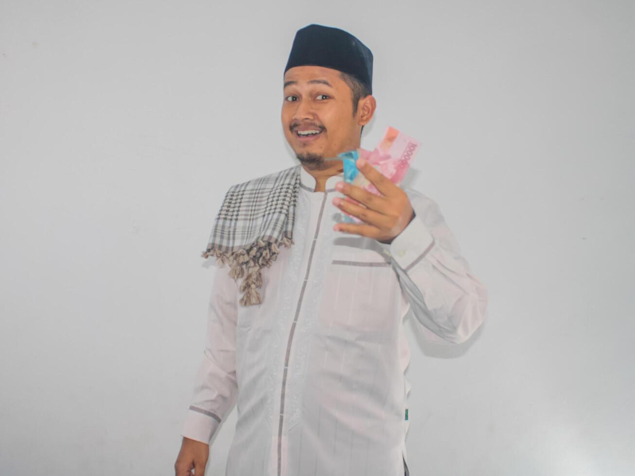 Asian Moslem man smiling happy while showing paper money photo