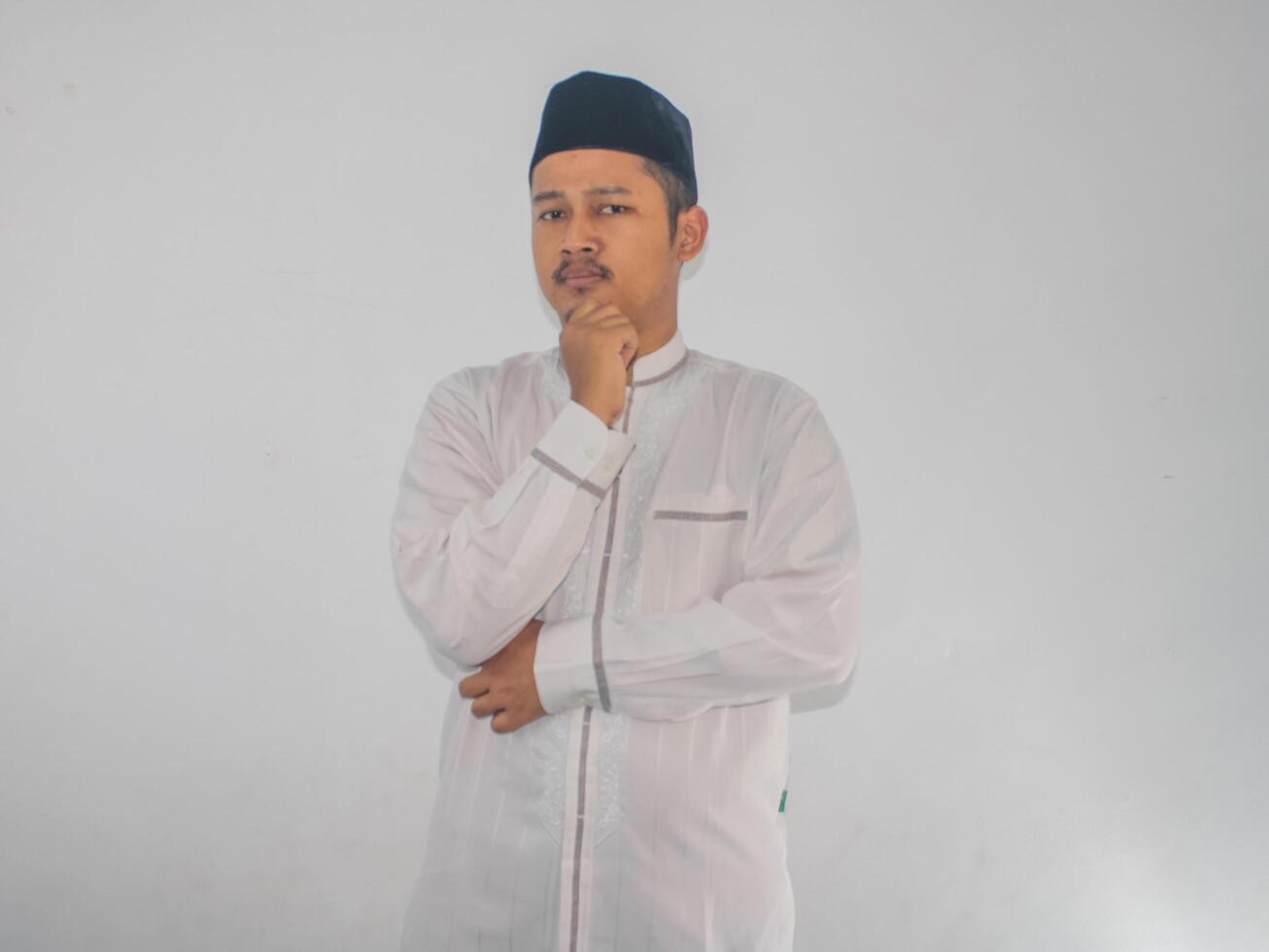 Moslem Asian man serious expression when thinking about something photo