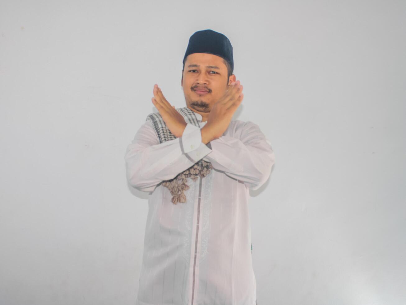 Adult Asian man showing angry expression while making stop hand sign photo