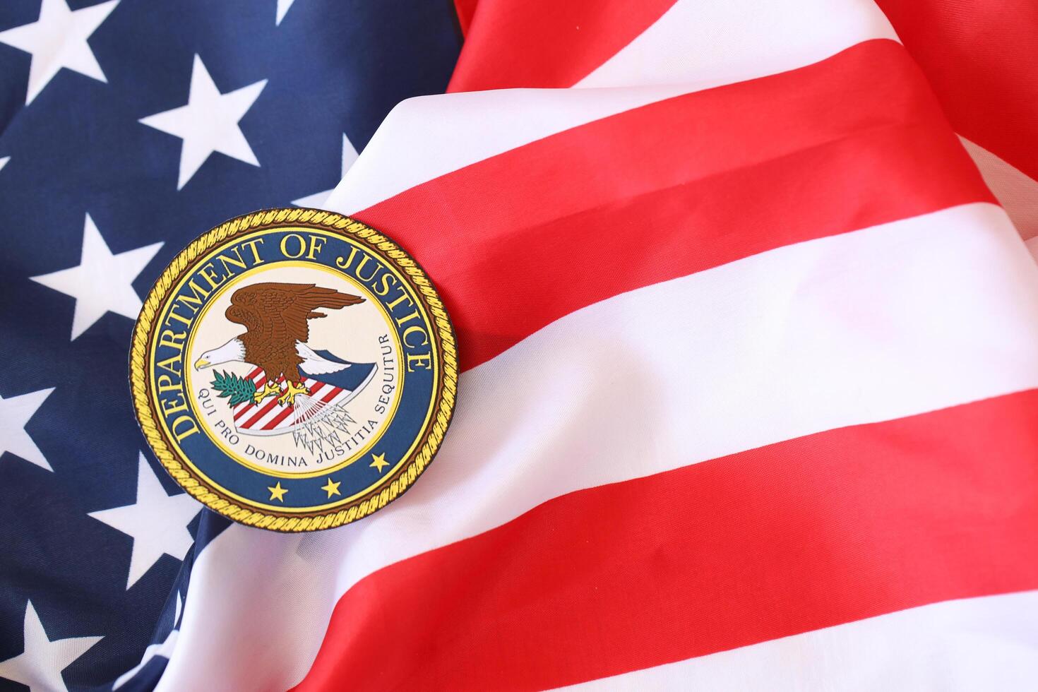 KYIV, UKRAINE - MARCH 9, 2024 US Department of Justice seal on United States of America flag photo