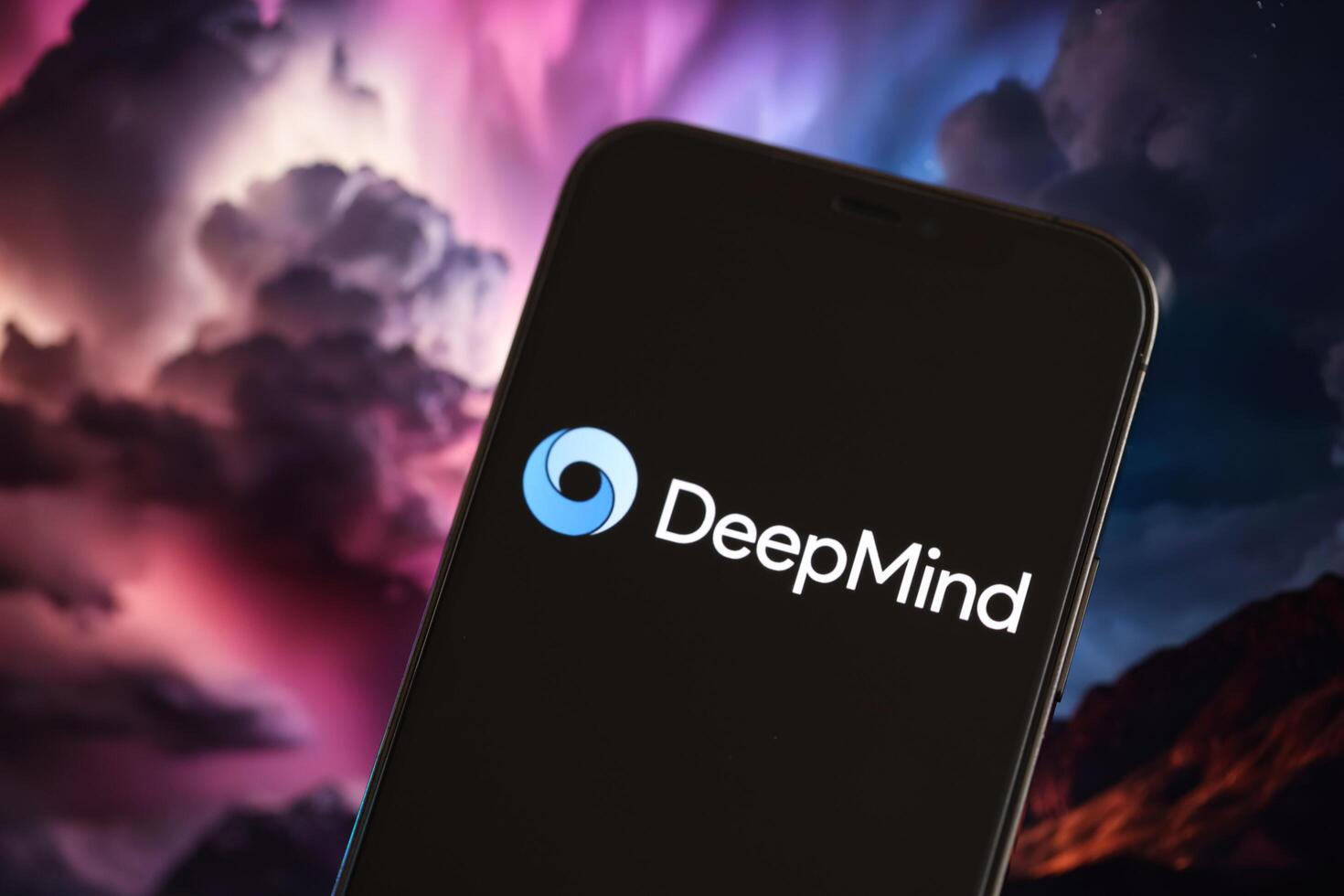 KYIV, UKRAINE - MARCH 17, 2024 DeepMind logo on iPhone display screen with background of artificial intelligence futuristic ai generated image photo