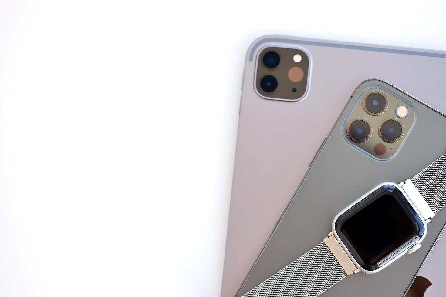 KYIV, UKRAINE - 4 MAY, 2023 Apple brand devices iphone, ipad with apple watch lies on macbook body photo