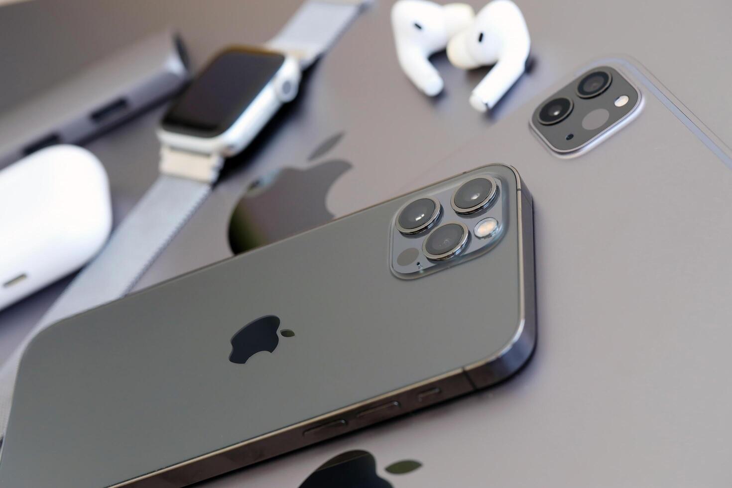 KYIV, UKRAINE - 4 MAY, 2023 Apple brand devices iphone, ipad and airpods with apple watch lies on macbook body photo
