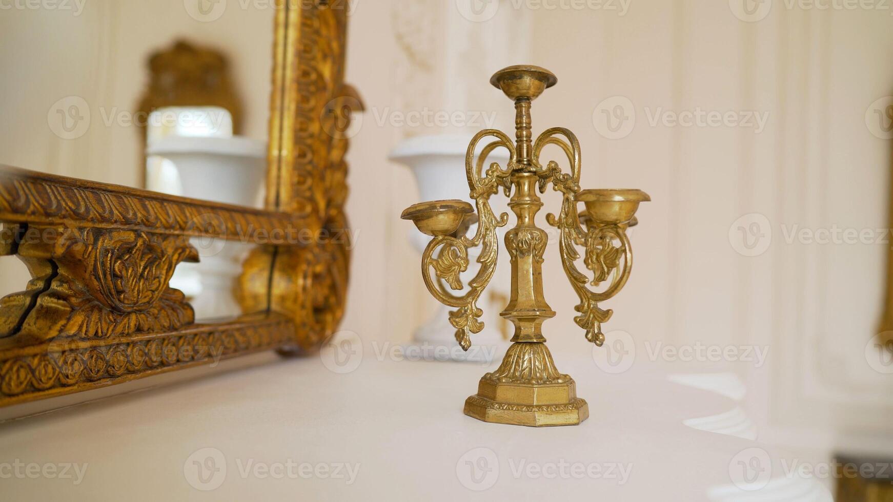 Classic bronze candlestick. One antique candlestick, bronze candle tree. Gold candlestick in a photo studio.