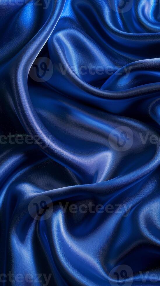 Elegant folds of royal blue silk create fluid waves and a visual flow, highlighting the luxurious texture and rich color. photo