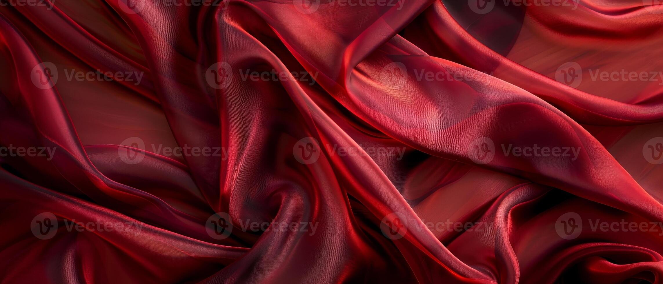 Luxurious burgundy satin fabric flows in soft waves and elegant folds, showcasing the rich texture and warm tones of the material. photo