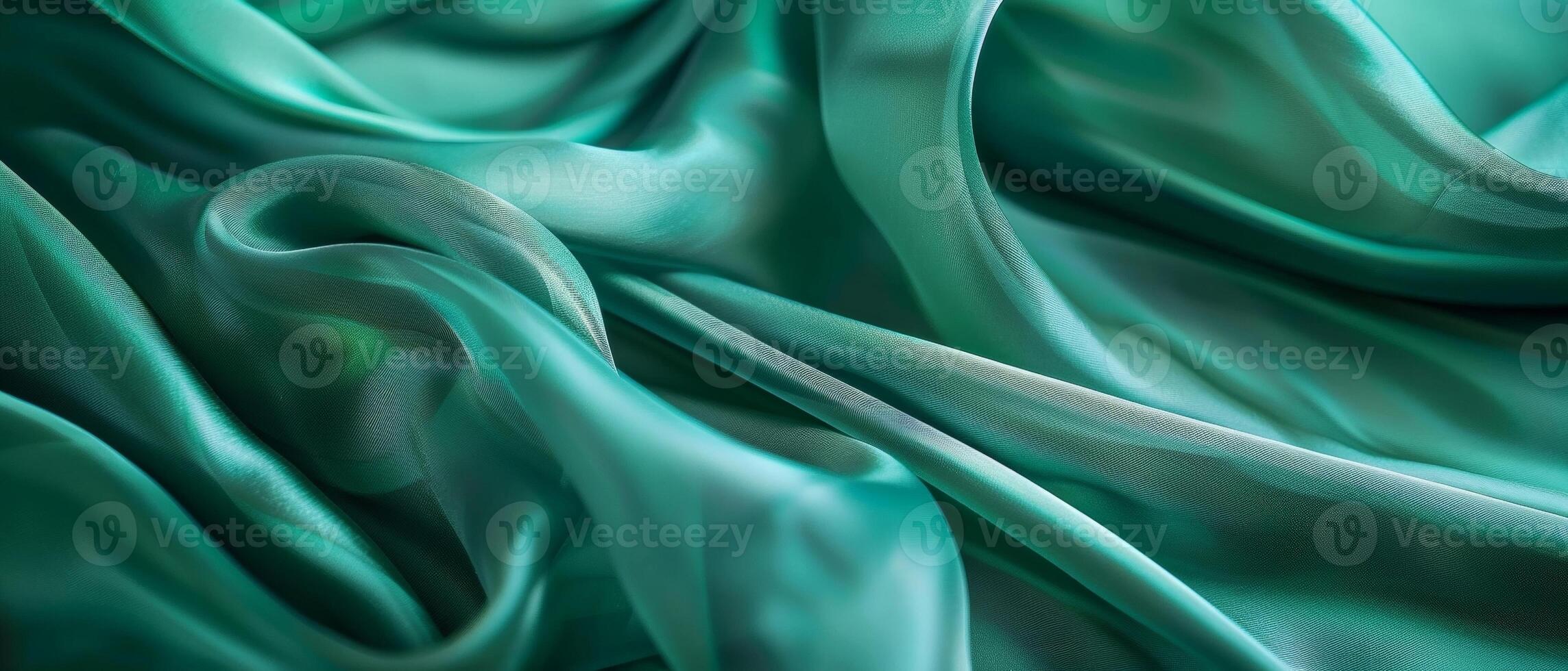 Smooth emerald green satin fabric draped in languorous waves, emphasizing the sleek and sumptuous look of the high-quality textile. photo