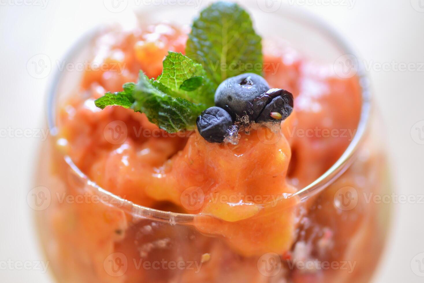 home made ice cream with raspberry, blackberry, mango fruits served in wine glasses. photo