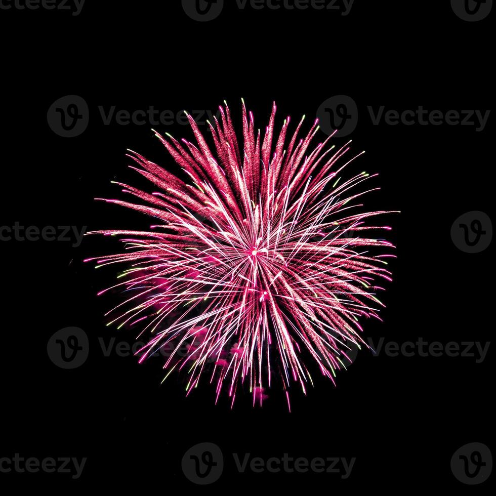 Colorful celebration fireworks isolated on black sky background. photo