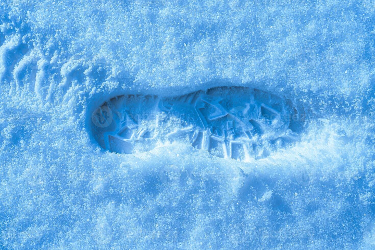 Boot track on a snow in winter. photo