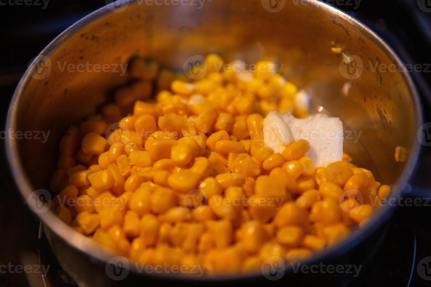 Cooking corn with butter photo