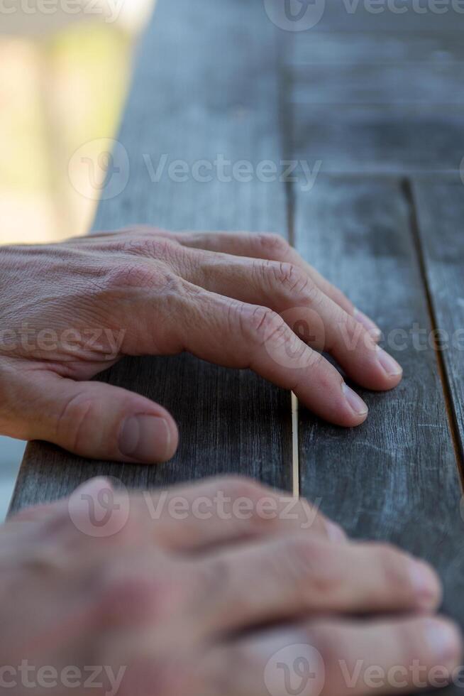 Mans hands on the table photo