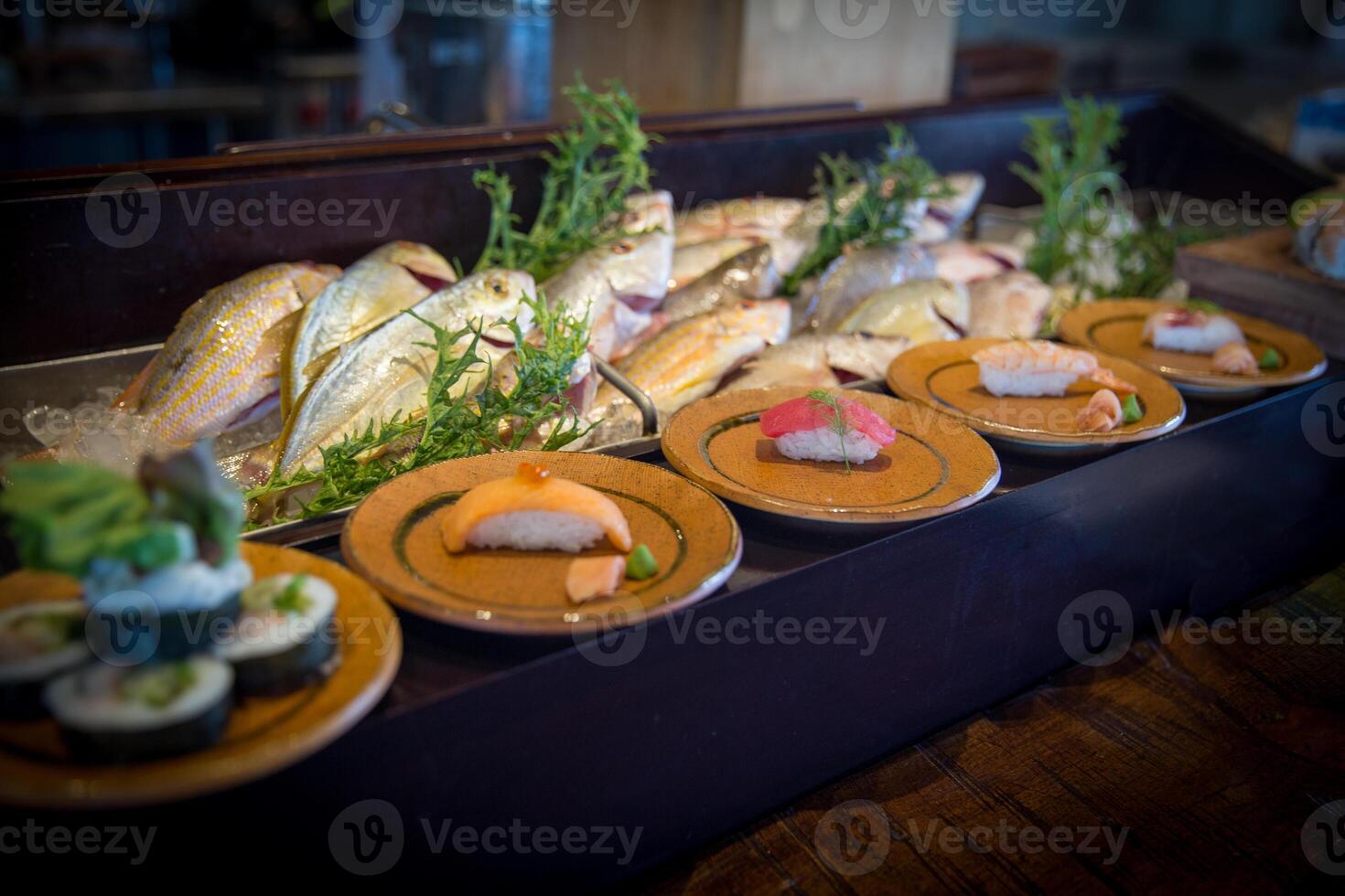 Sushi Displayed with fresh fish photo