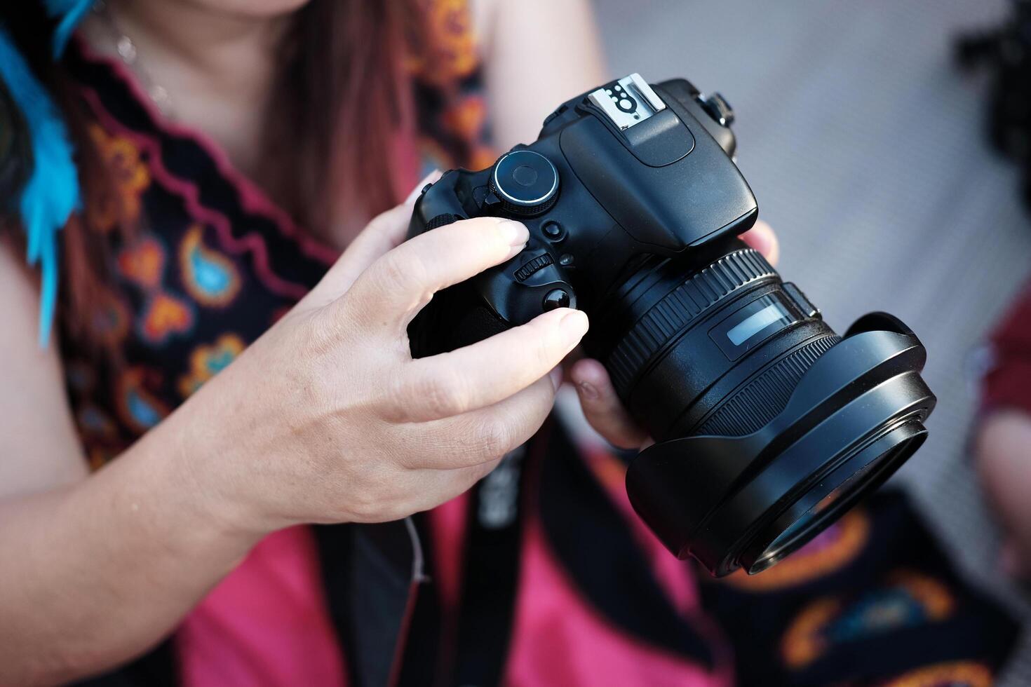 Close up woman hand holding digital camera photo