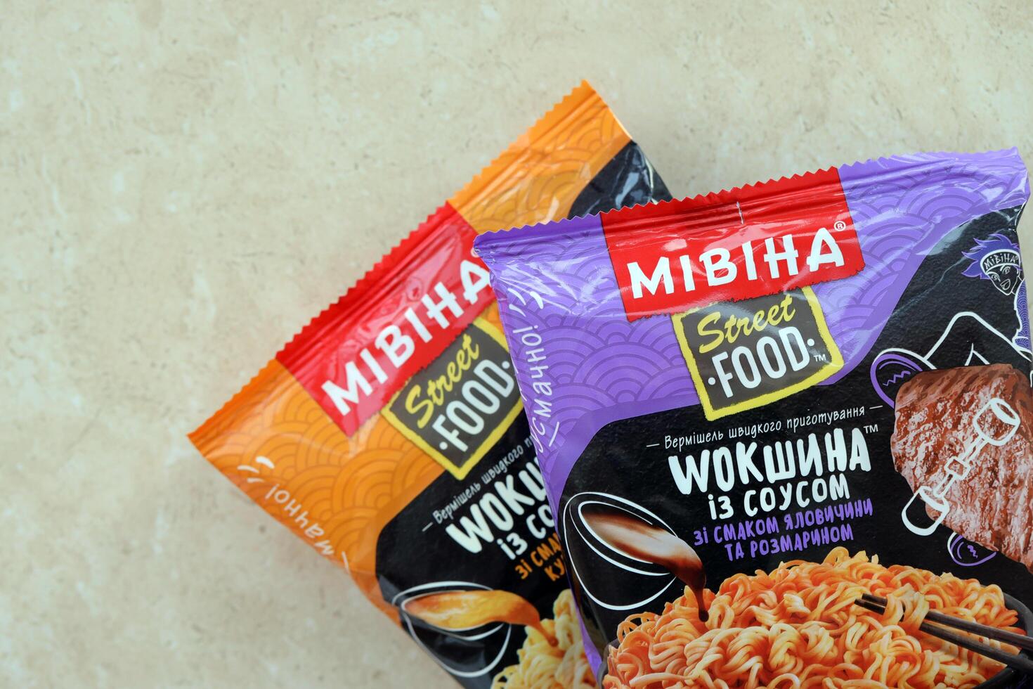 KYIV, UKRAINE - OCTOBER 31, 2023 Packs of Mivina Street Food instant noodles wokshina with honey chicken flavour. Mivina is Ukrainian manufacturer of instant noodles photo