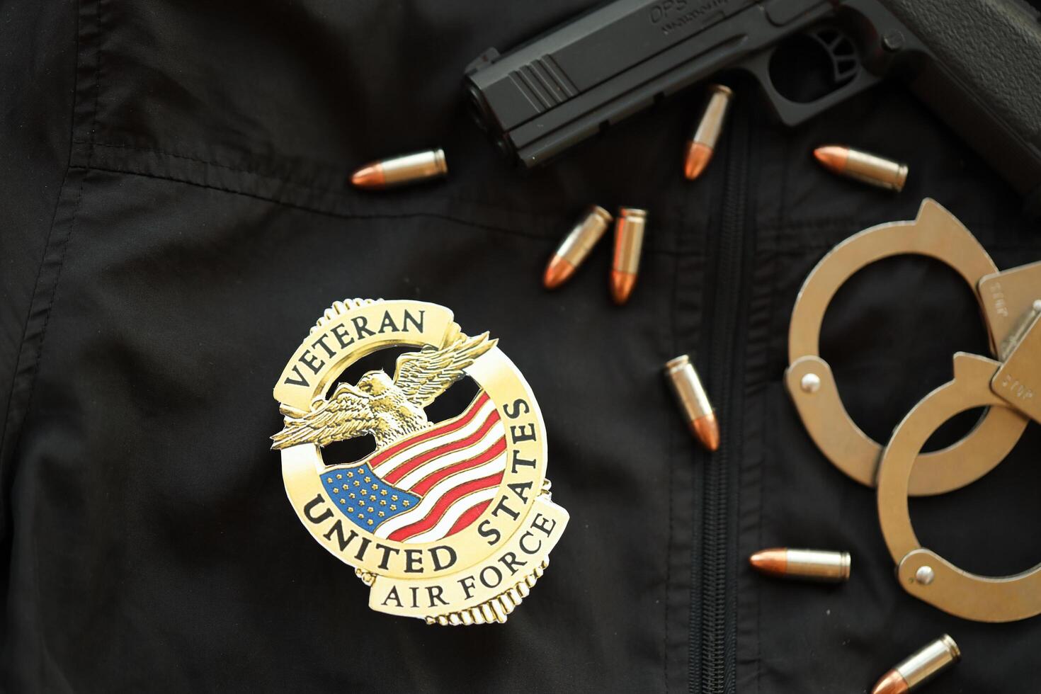 KYIV, UKRAINE - MARCH 9, 2024 US Air Force Veteran badge on black jacket uniform with gun, bullets and handcuffs photo