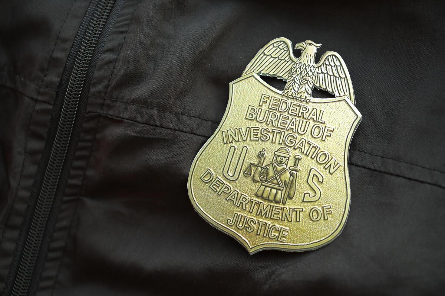 KYIV, UKRAINE - MARCH 9, 2024 US FBI Federal Bureau of Investigation badge on black jacket uniform photo