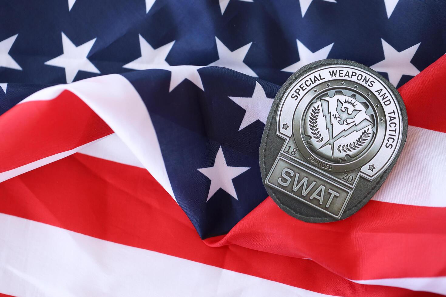 KYIV, UKRAINE - MARCH 9, 2024 US SWAT badge on United States of America flag photo