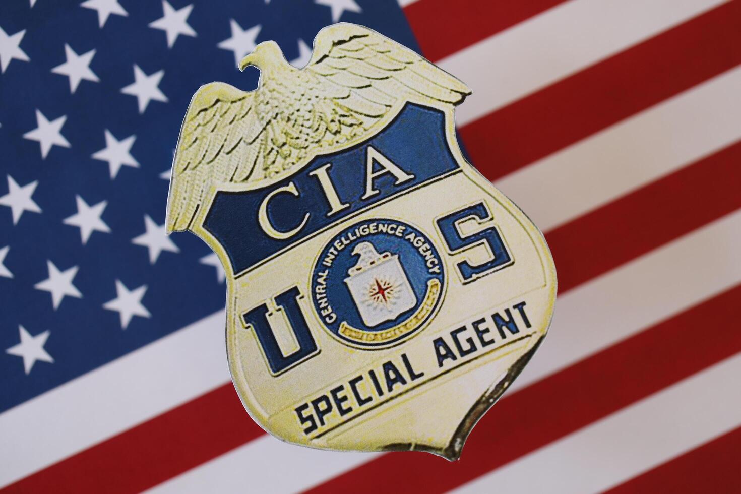 KYIV, UKRAINE - MARCH 9, 2024 US CIA Central Intelligence Agency badge on United States of America flag photo