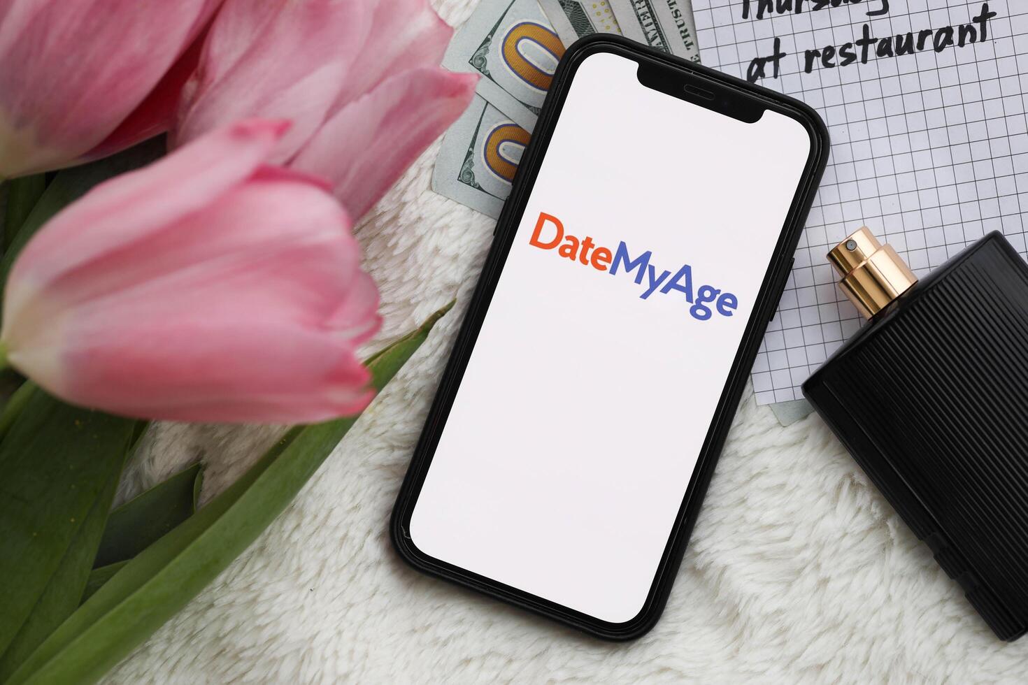 KYIV, UKRAINE - FEBRUARY 23, 2024 DateMyAge logo of famous dating website or app on iPhone display photo