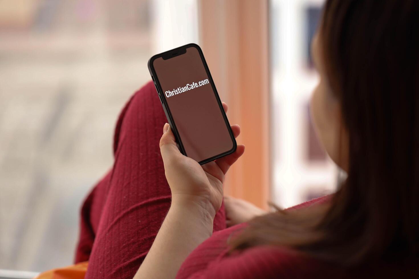 KYIV, UKRAINE - FEBRUARY 23, 2024 ChristianCafe logo of famous dating website or app on iPhone display photo