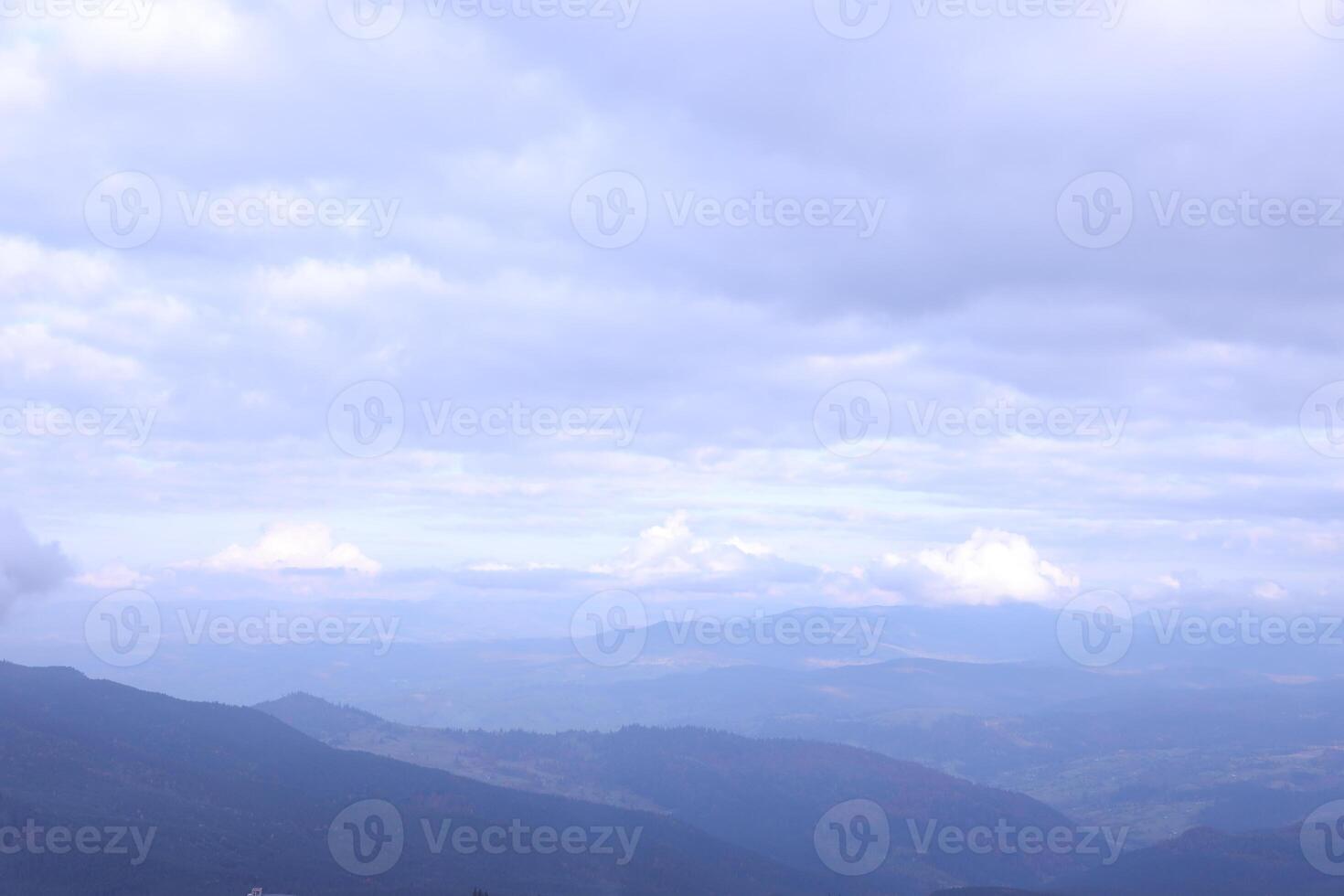 Morning view from the Dragobrat mountain peaks in Carpathian mountains, Ukraine. Cloudy and foggy landscape around Drahobrat Peaks photo
