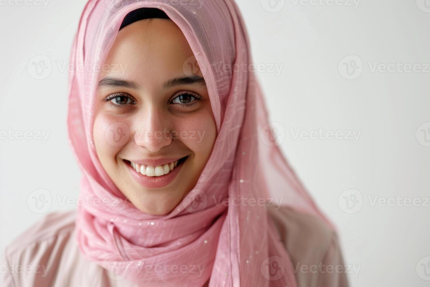 AI generated Portrait of young Muslim woman in pink hijab smiling. photo