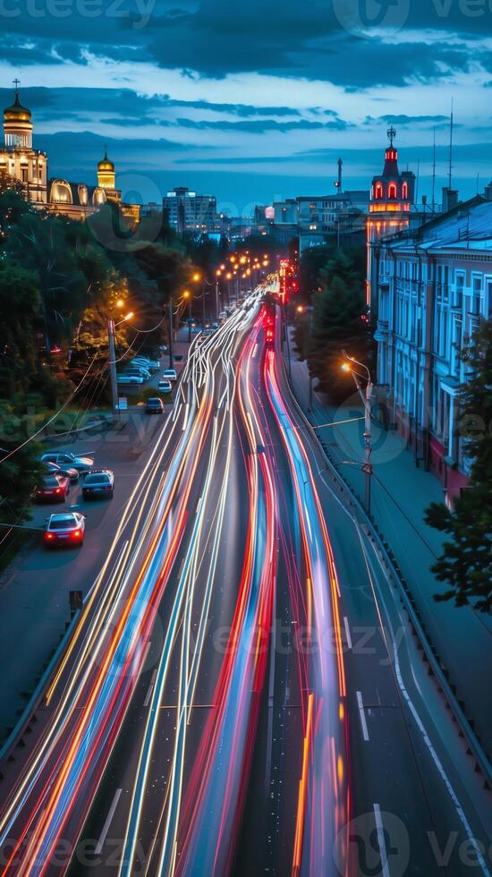 Streaks of moving car lights against the backdrop of city lights at night photo