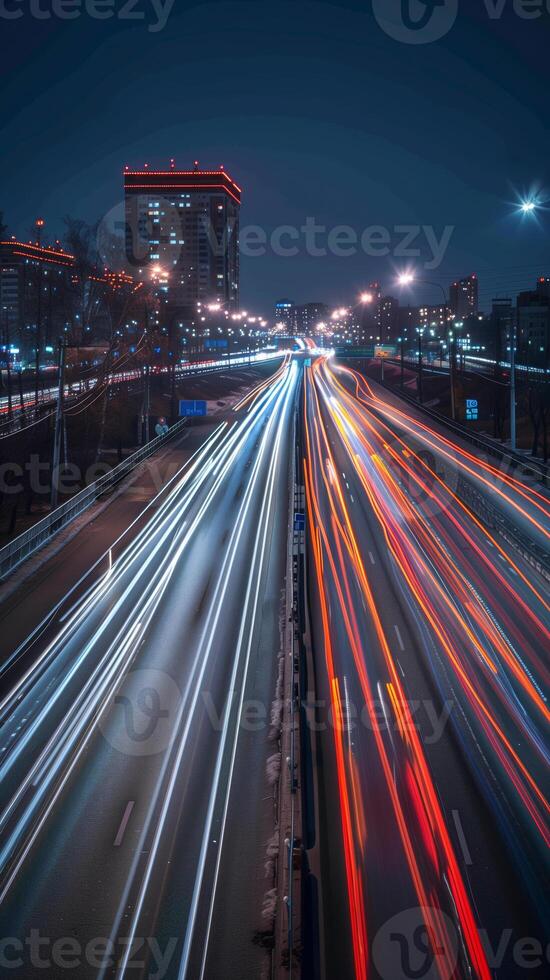 Streaks of moving car lights against the backdrop of city lights at night photo