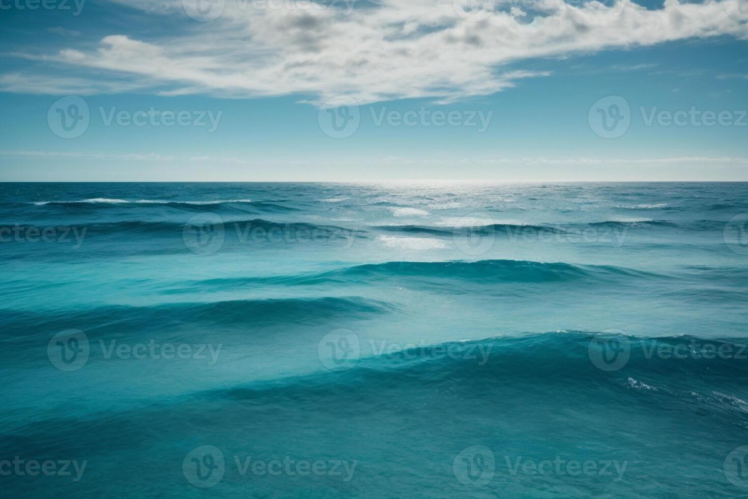 a beautiful blue ocean with waves and clouds photo