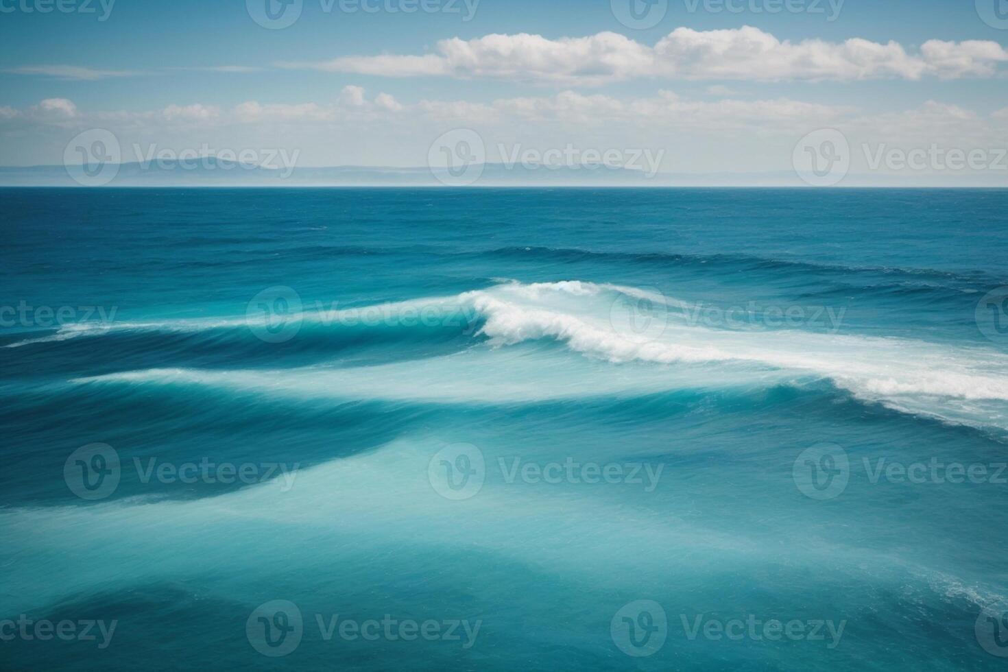 a beautiful blue ocean with waves and clouds photo