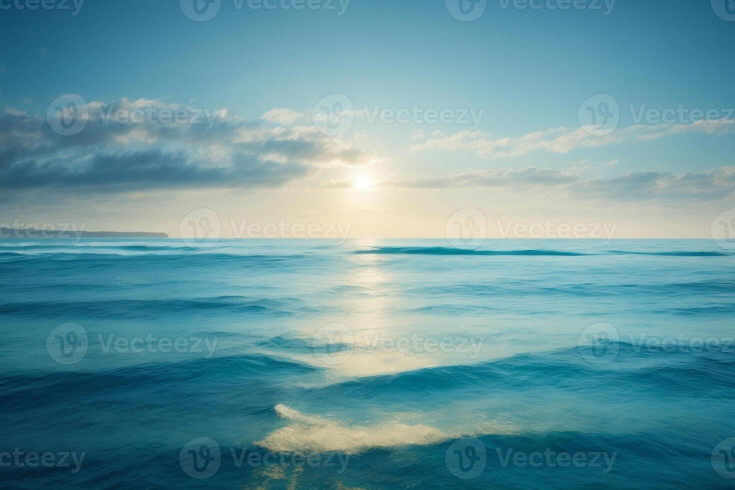 blue ocean with mountains and clouds photo