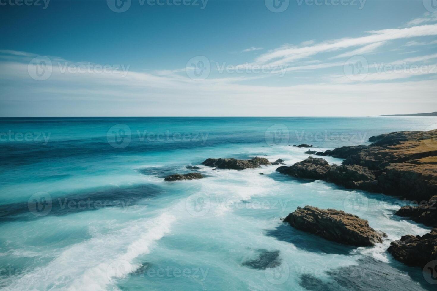 blue ocean with mountains and clouds photo