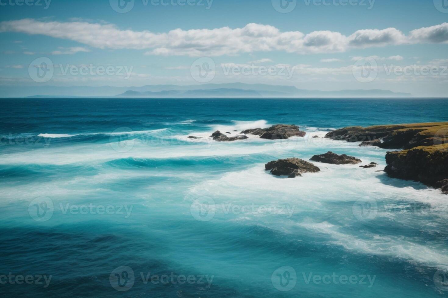 blue ocean with mountains and clouds photo