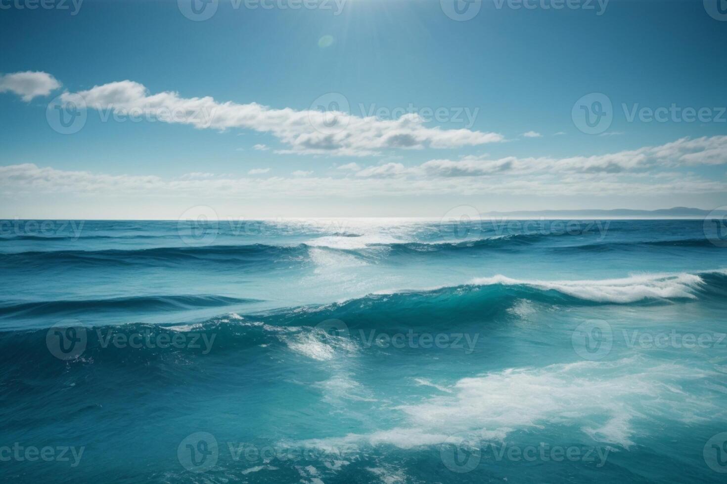 blue ocean with mountains and clouds photo