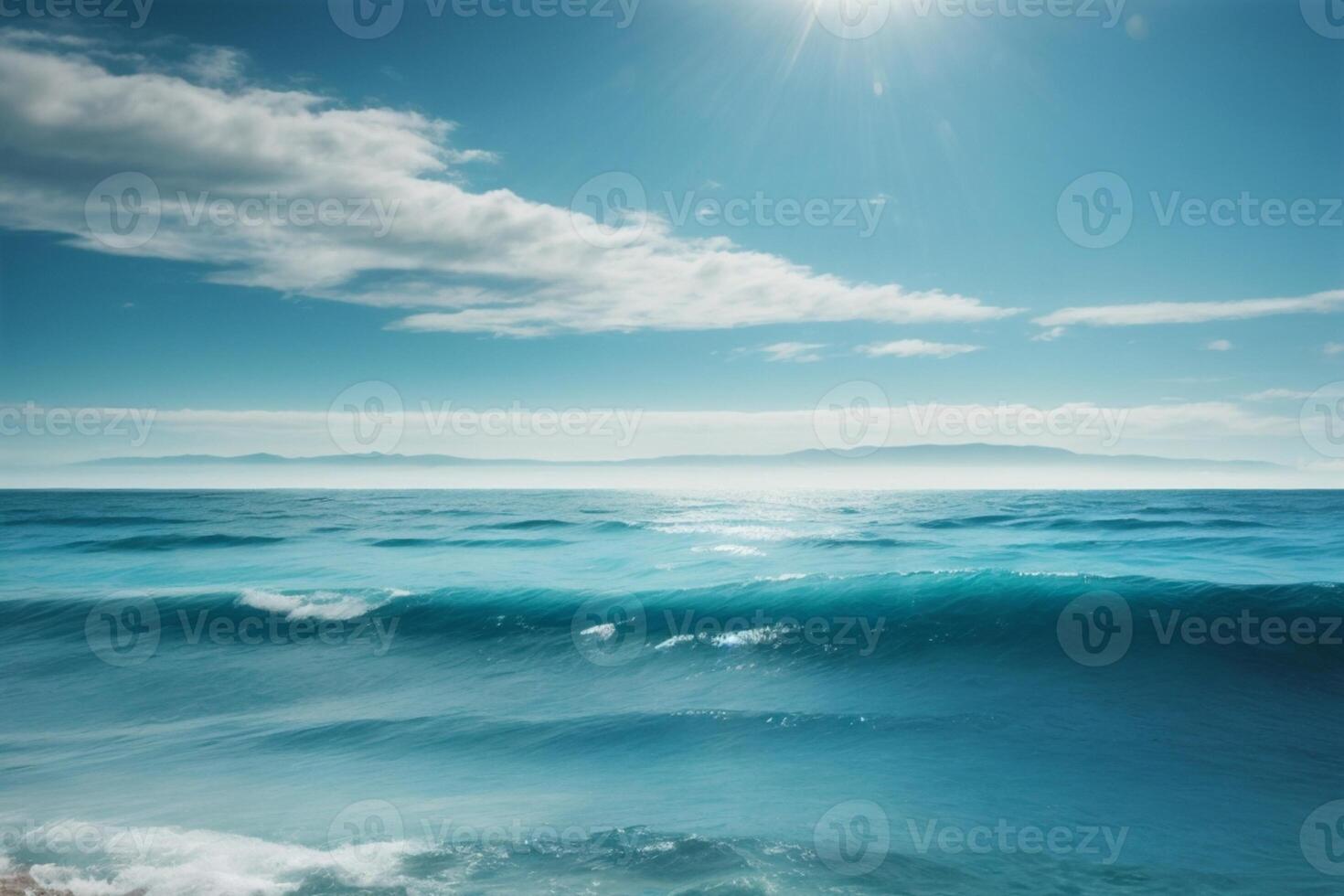 blue ocean with clouds and sun in the sky photo