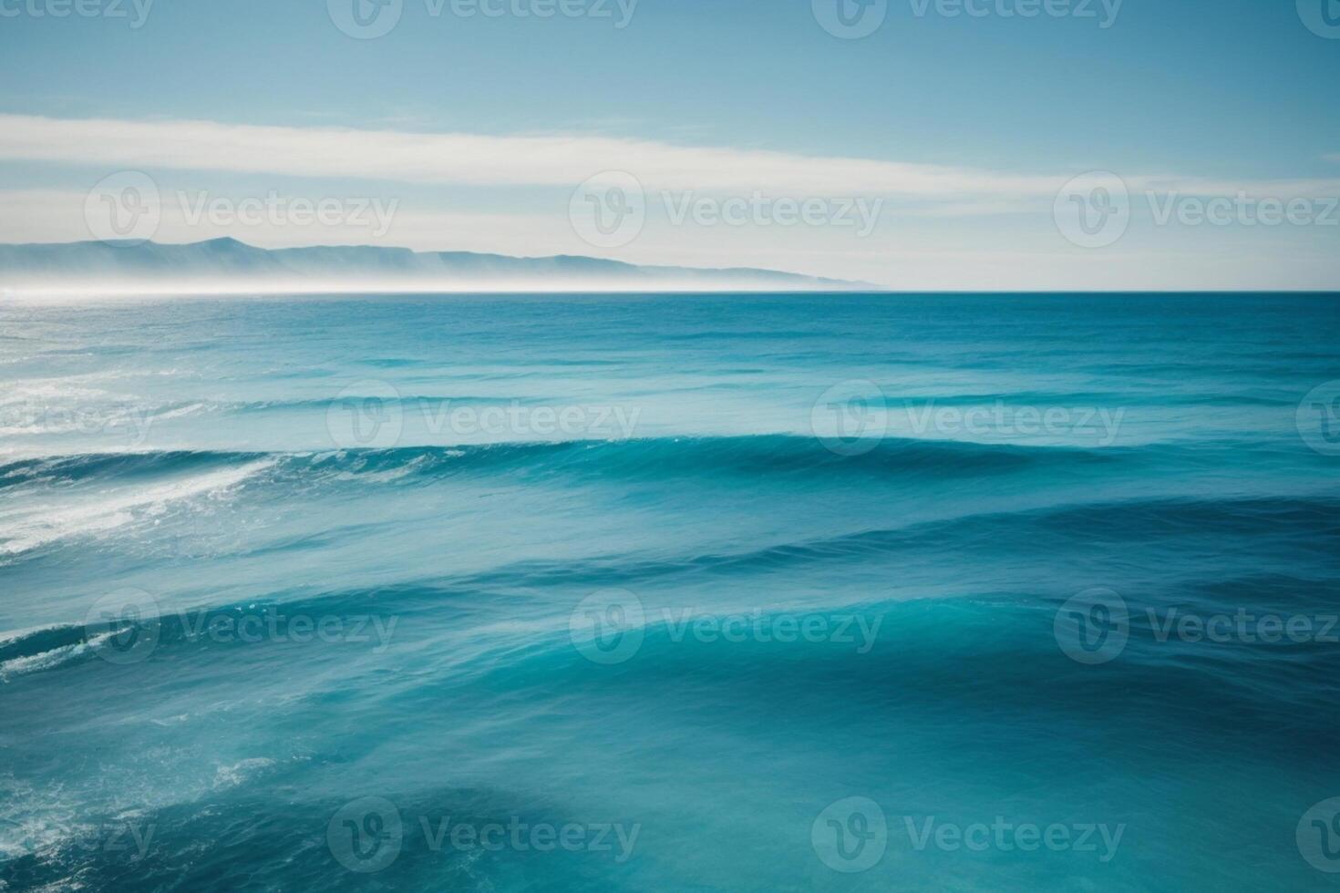 a beautiful beach with waves and blue sky photo