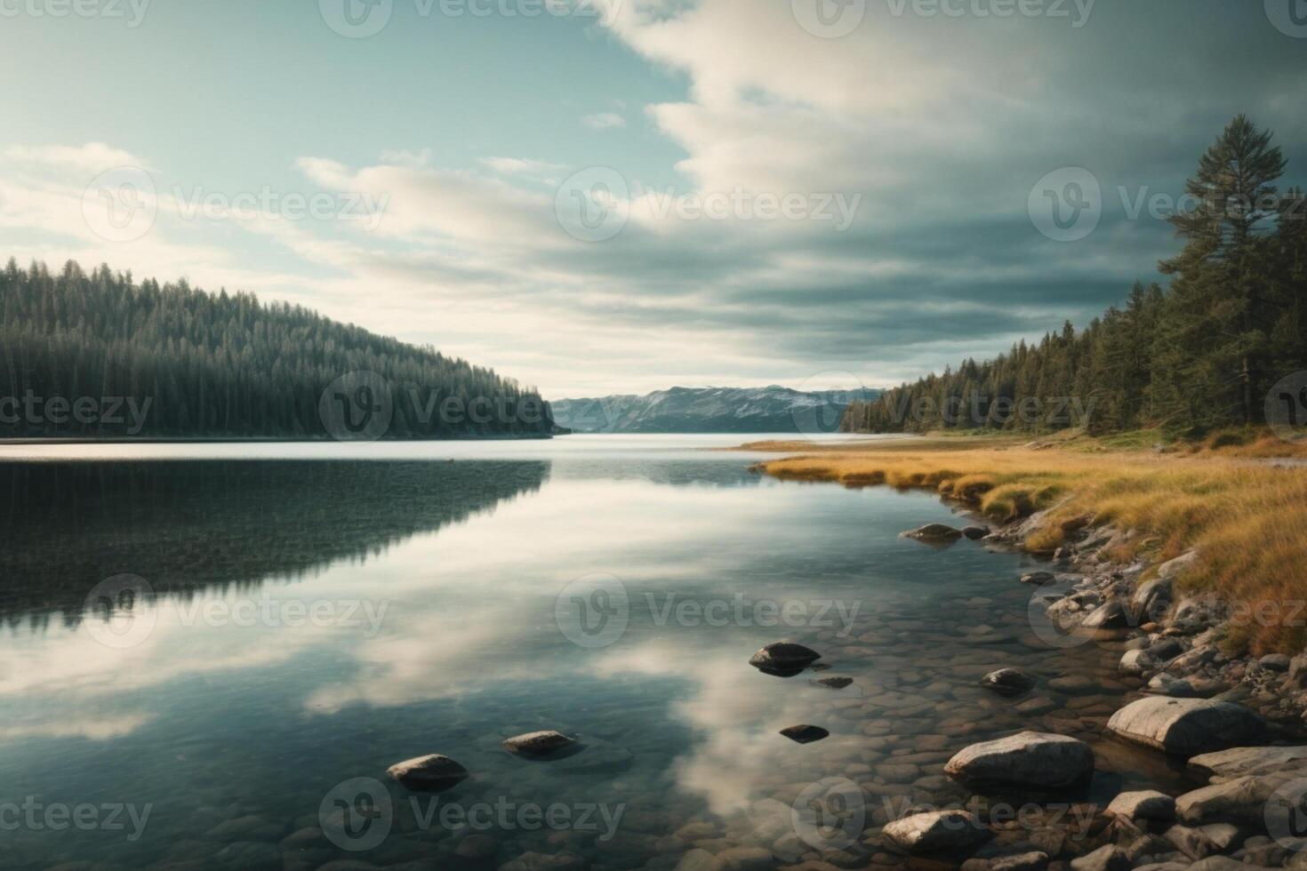 a lake with rocks and trees at sunset photo