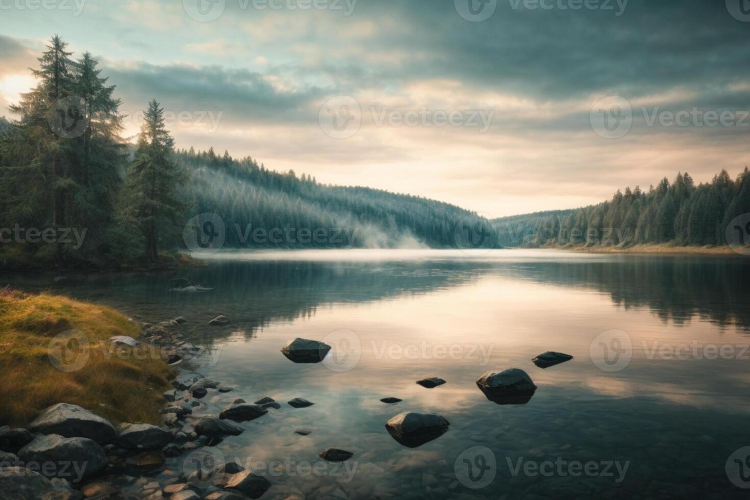 a lake with rocks and trees at sunset photo