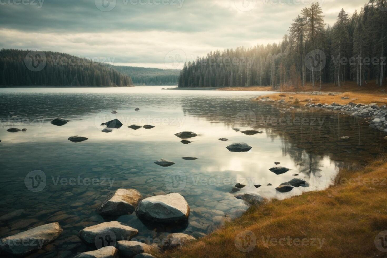 a mountain lake surrounded by grass and trees photo