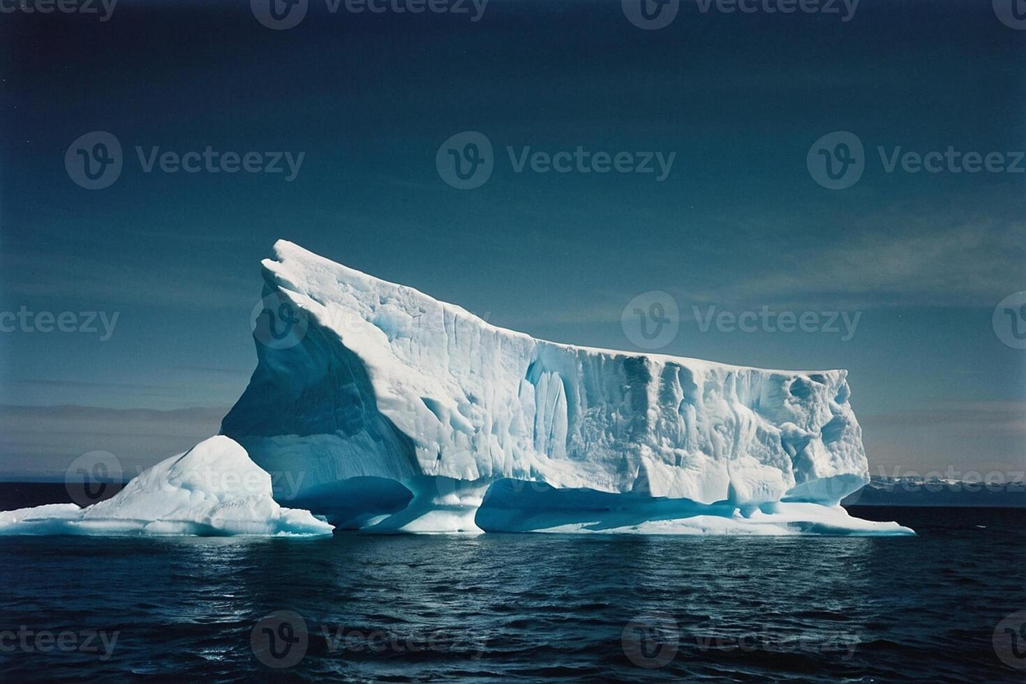 icebergs floating in the water at sunset photo