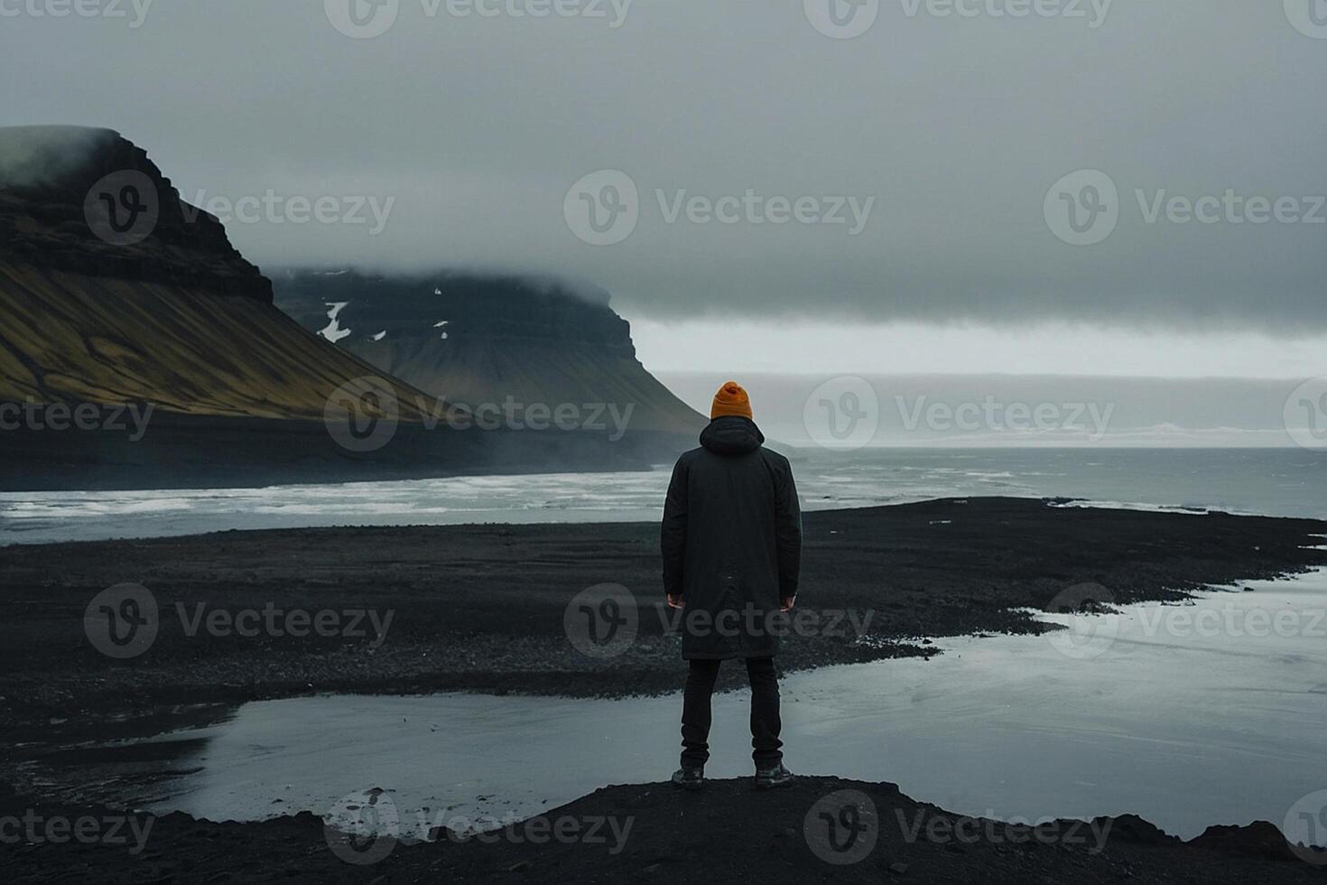 man standing on the edge of a cliff overlooking the Irish landscape photo