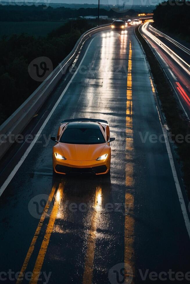 a sports car driving on a wet road at night photo
