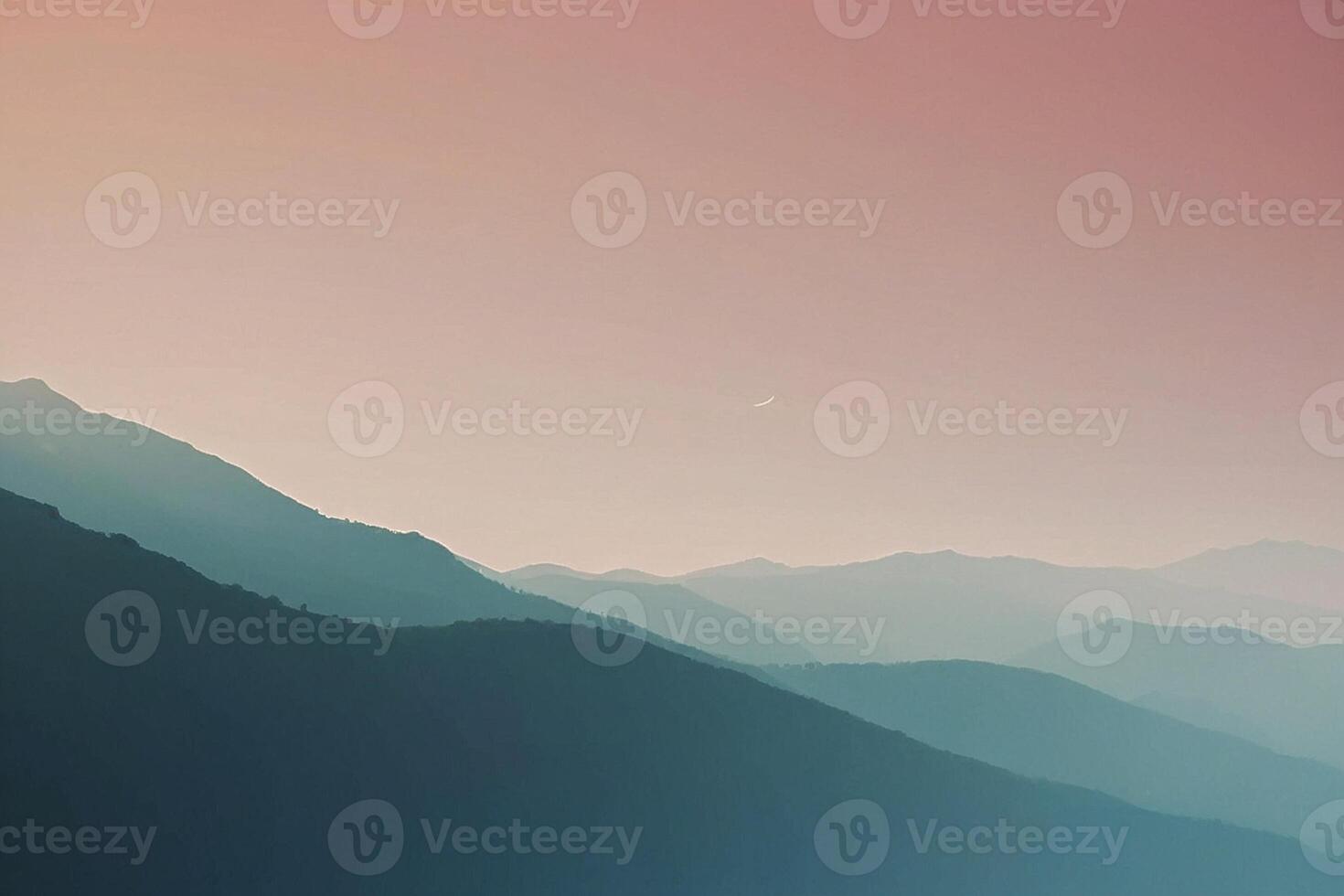 a mountain range with a sunset in the background photo