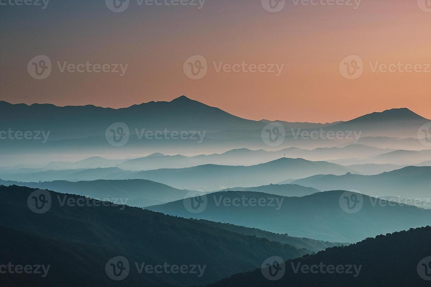 a mountain range with a sunset in the background photo